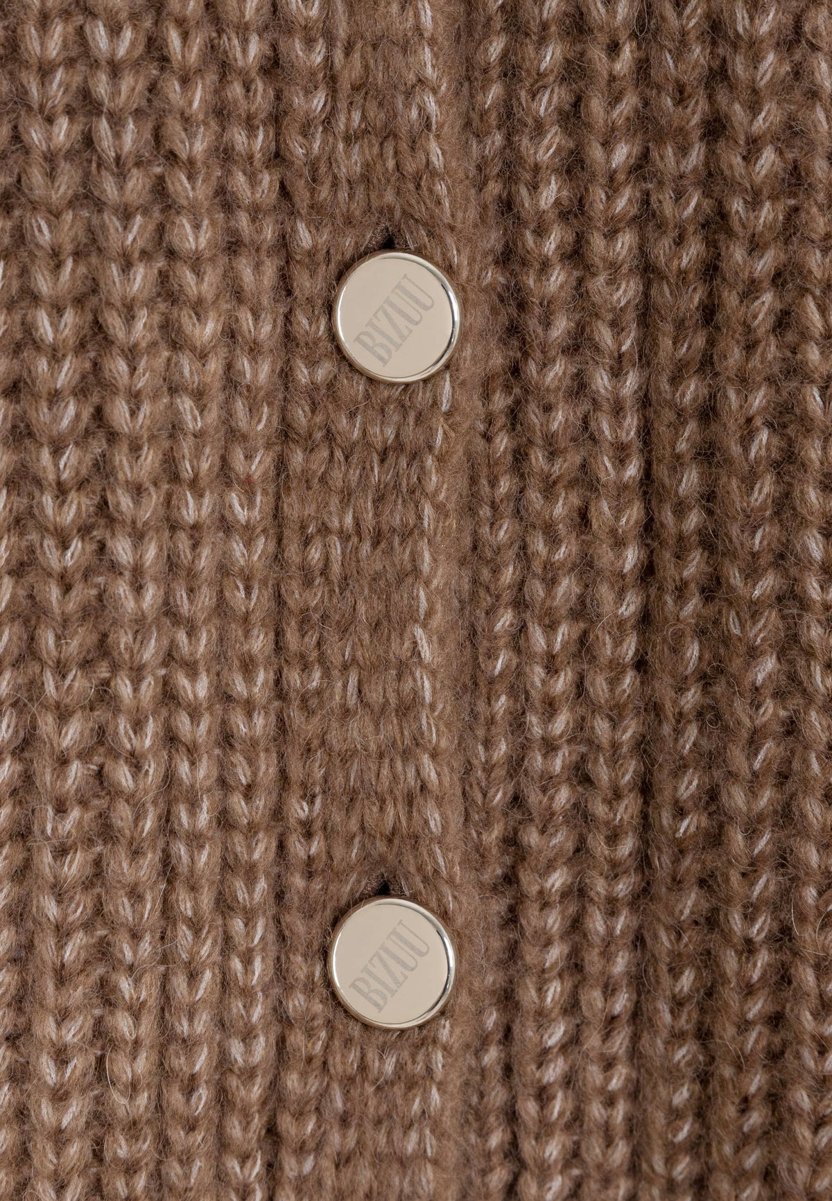 Close-up of the branded buttons on the brown ORNAMY sweater.