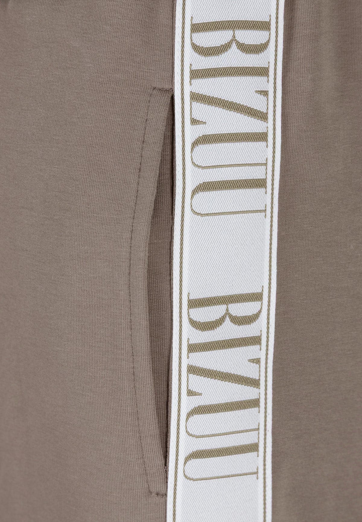 A close-up of the stripe on PETRA's sweatpants.