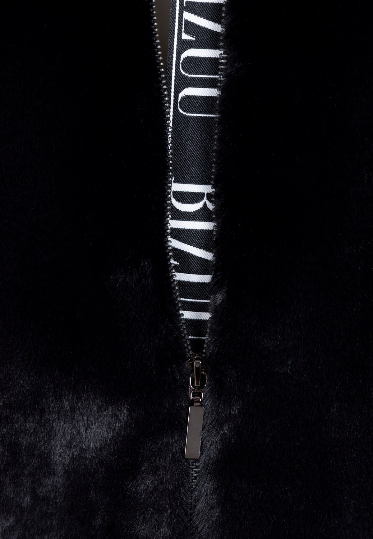 Close-up of the branded tape along the zipper of the PIACENZA jacket.