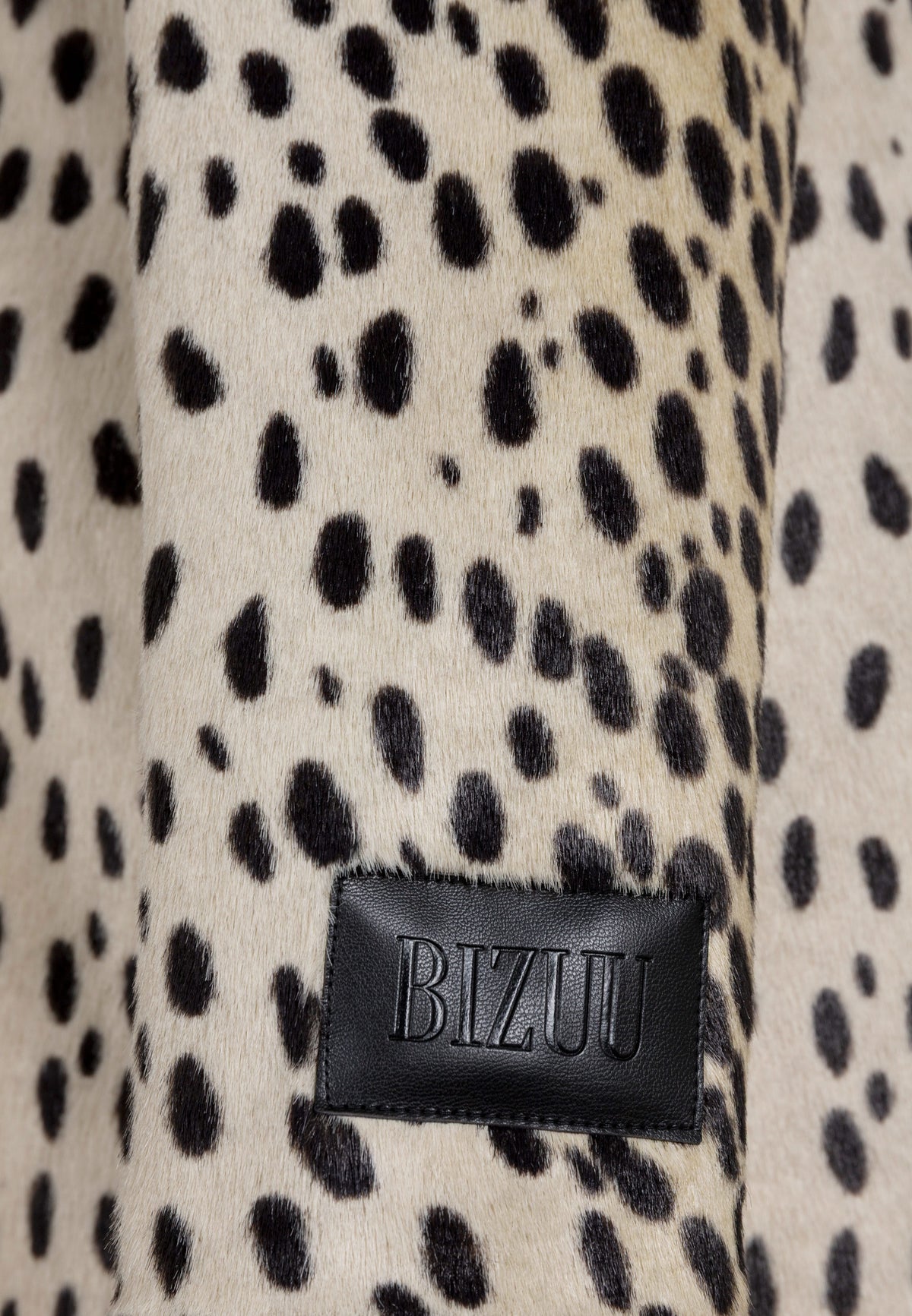 Close-up of the embossed logo label on the sleeve of the PONTICELLI coat.