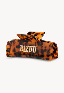 Brown RHODI hair clip with logo.