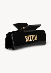 Black RHODI hair clip with logo.