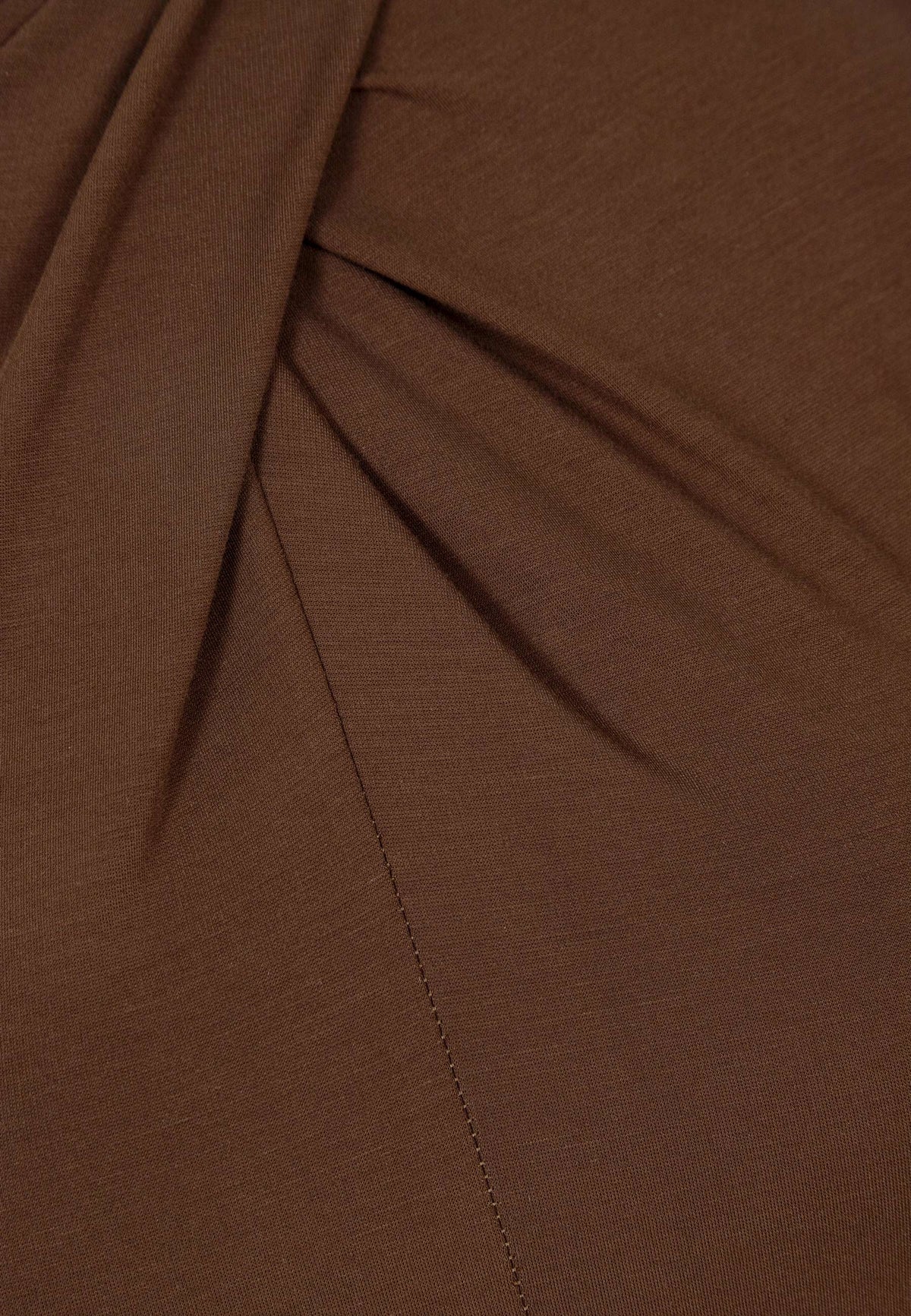 Close-up of the decorative gathering on the brown ROTTA dress.