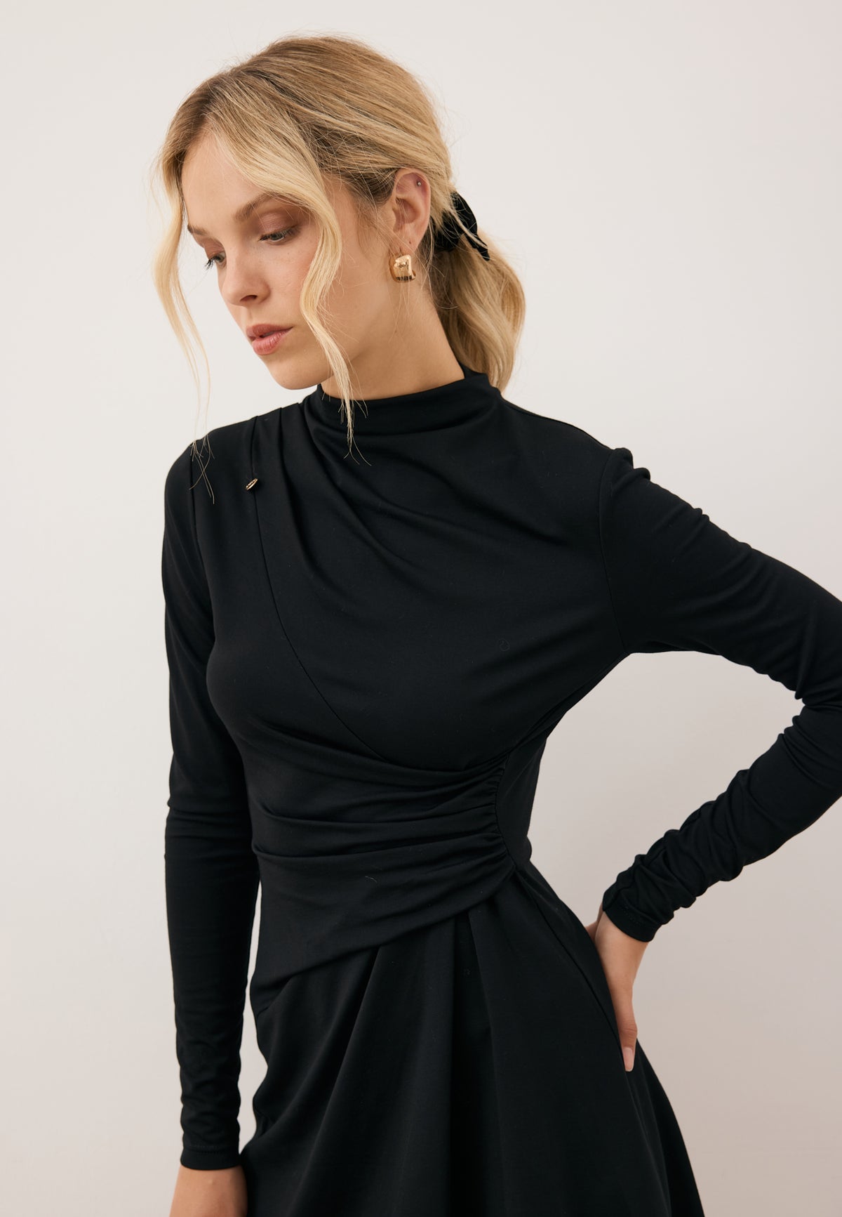 Close-up of the model in the SALOMEI dress highlighting the decorative front ruching.