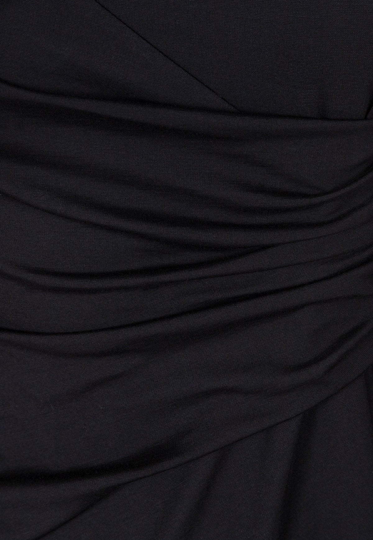 Close-up of the decorative ruching on the black SALOMEI dress.