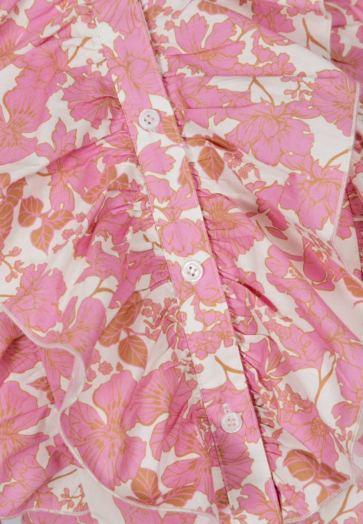 Close-up of the print and ruffles on the SANNI shirt.