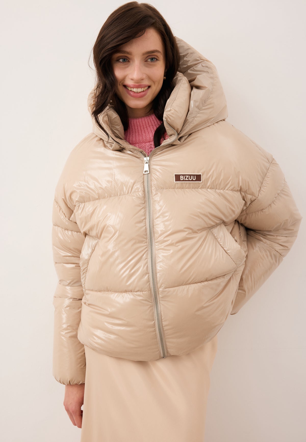 Smiling model in the beige SANYA down jacket.
