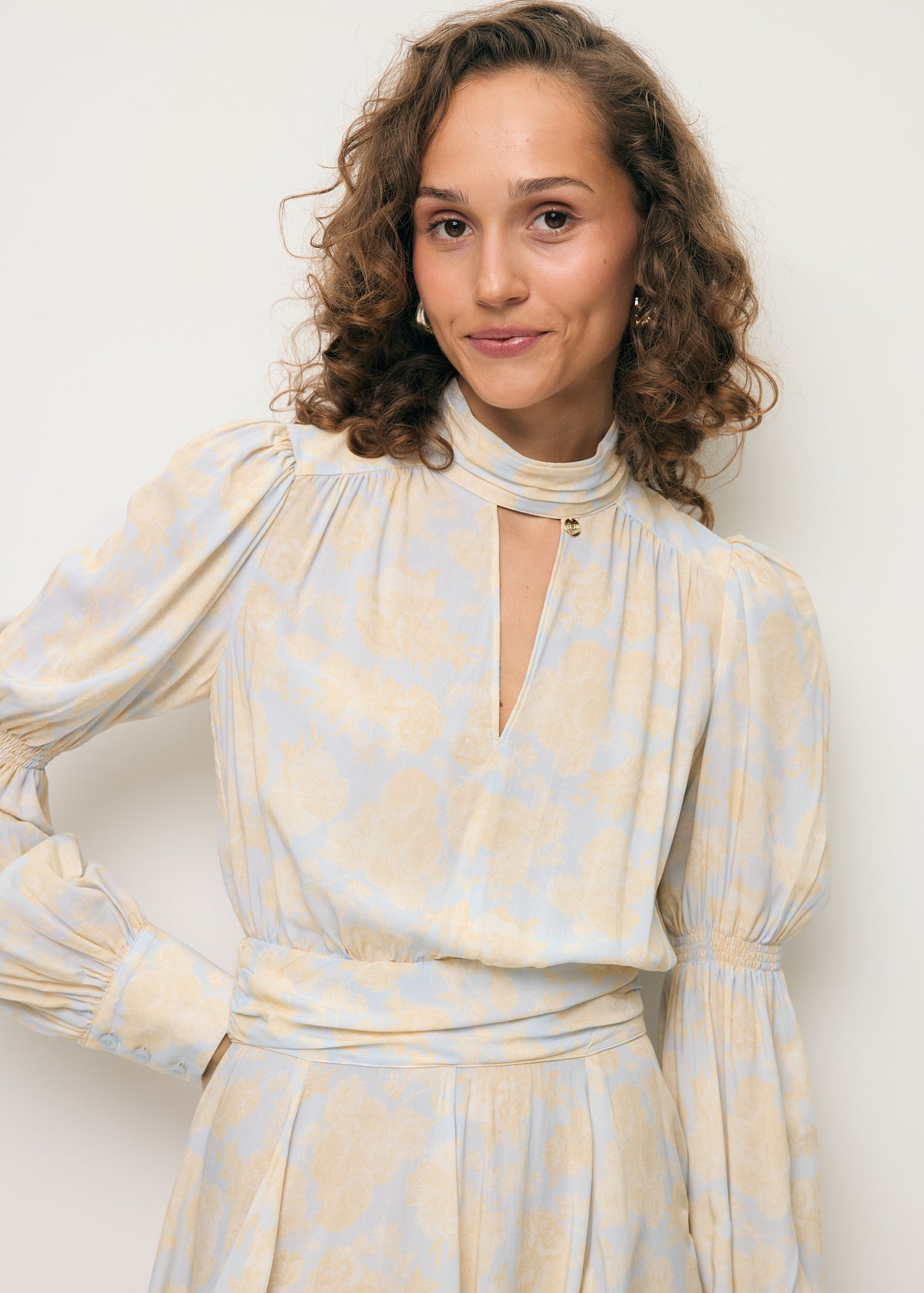 Close-up of the decorative neckline on the SIERRA dress.
