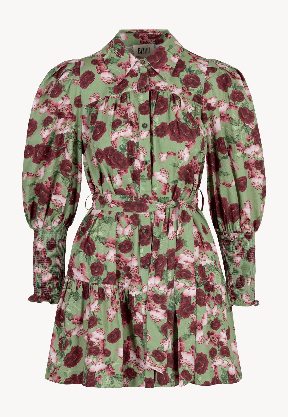 Close-up of a model wearing a green SOREZIA mini dress with a floral print.