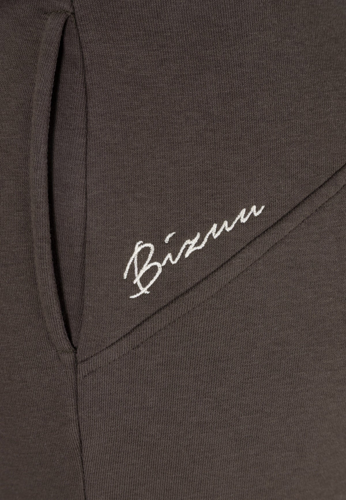 Close-up of the BIZUU embroidered logo on the back of the ZEIA sweatpants.