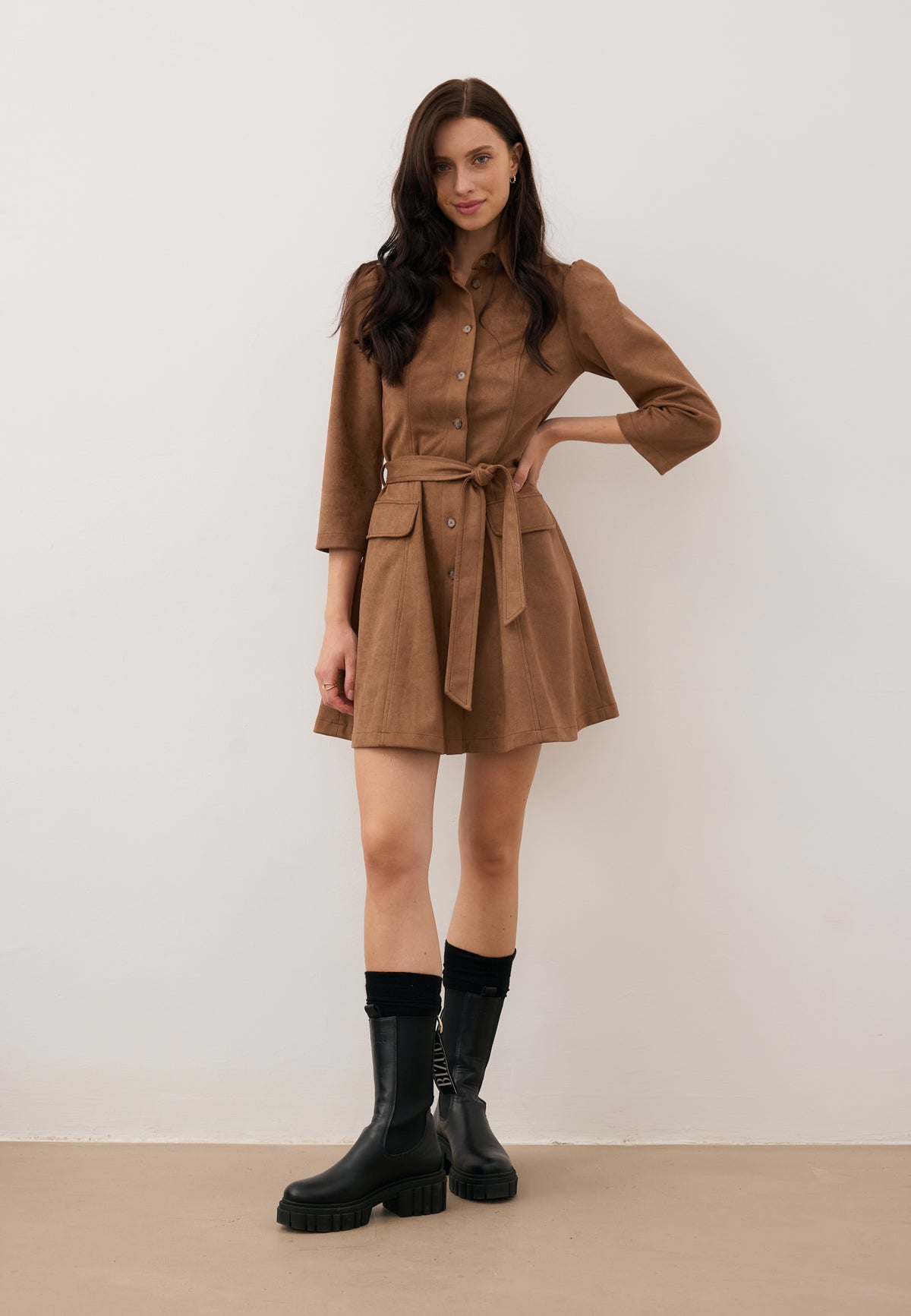 Model wearing the suede ZORELLE dress with a defined waist, paired with TORIDE leather ankle boots.