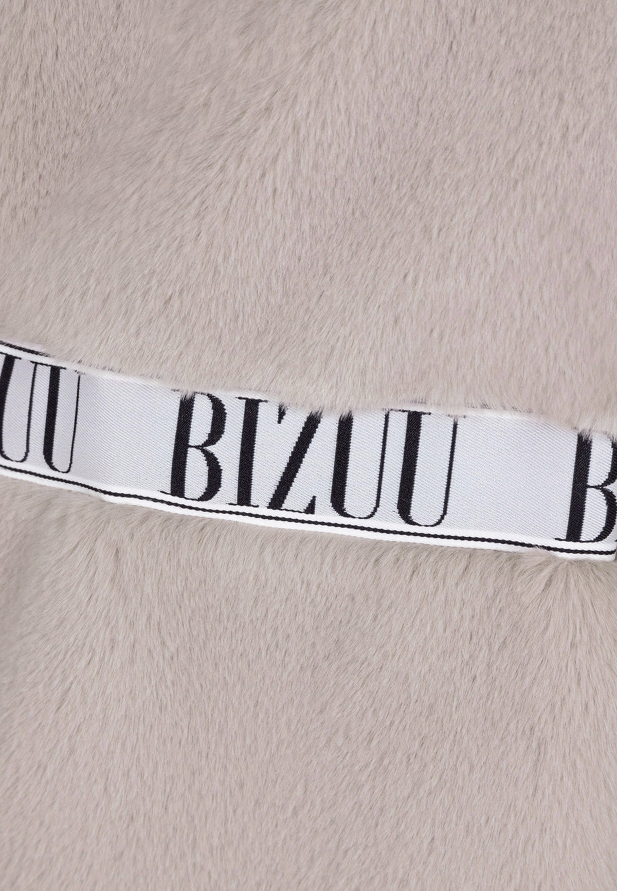 Close-up of the branded tape on the GREGORIA coat.